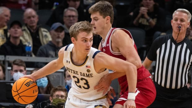 Dec 18, 2021; Indianapolis, Indiana, USA; Notre Dame Fighting Irish guard Dane Goodwin (23) dribbles the ball while Indiana Hoosiers forward Miller Kopp (12) defends in the second half at Gainbridge Fieldhouse. Mandatory Credit: Trevor Ruszkowski-USA TODAY Sports